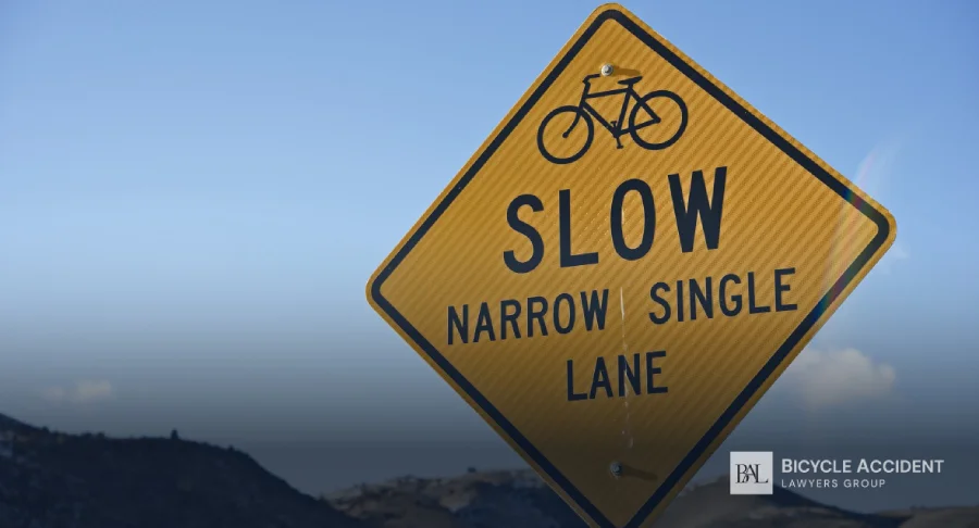 A yellow diamond-shaped road sign reads 