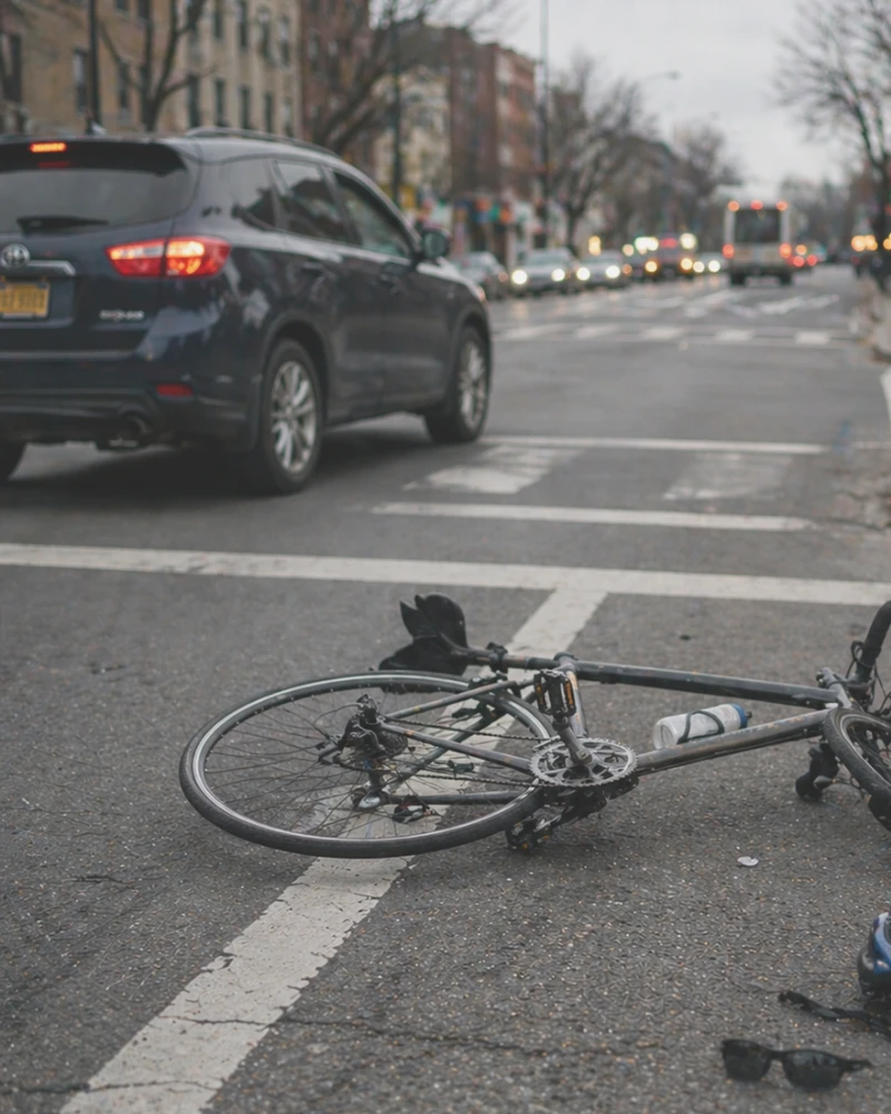 Bicycle lying in crosswalk after collision with car at city intersection